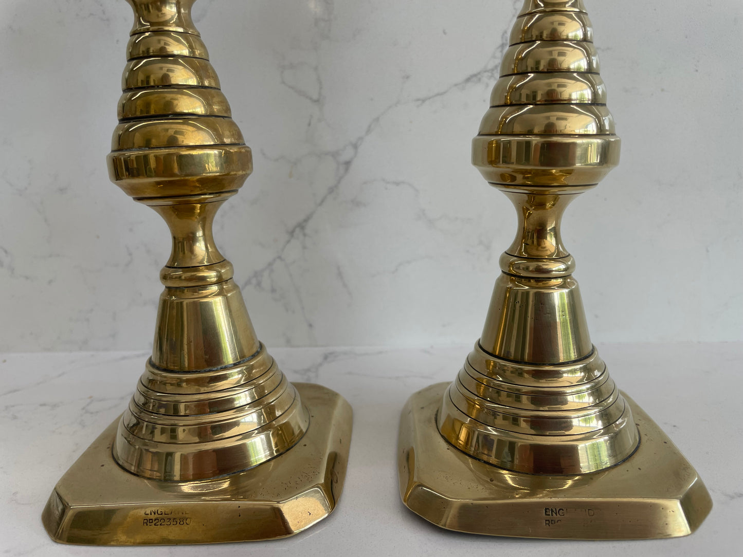 Unique pair of antique English Victorian 19th Century brass candlesticks stamped with Registration Design 223580 with 2 matching 100% London Beeswax candles
