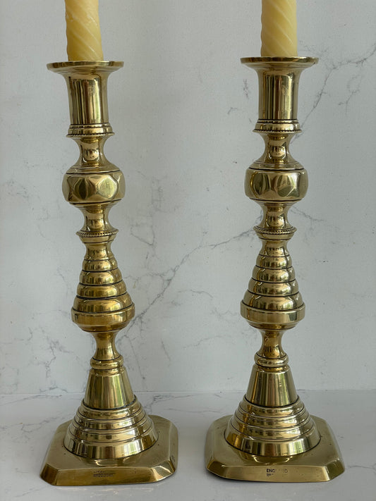 Unique pair of antique English Victorian 19th Century brass candlesticks stamped with Registration Design 223580 with 2 matching 100% London Beeswax candles