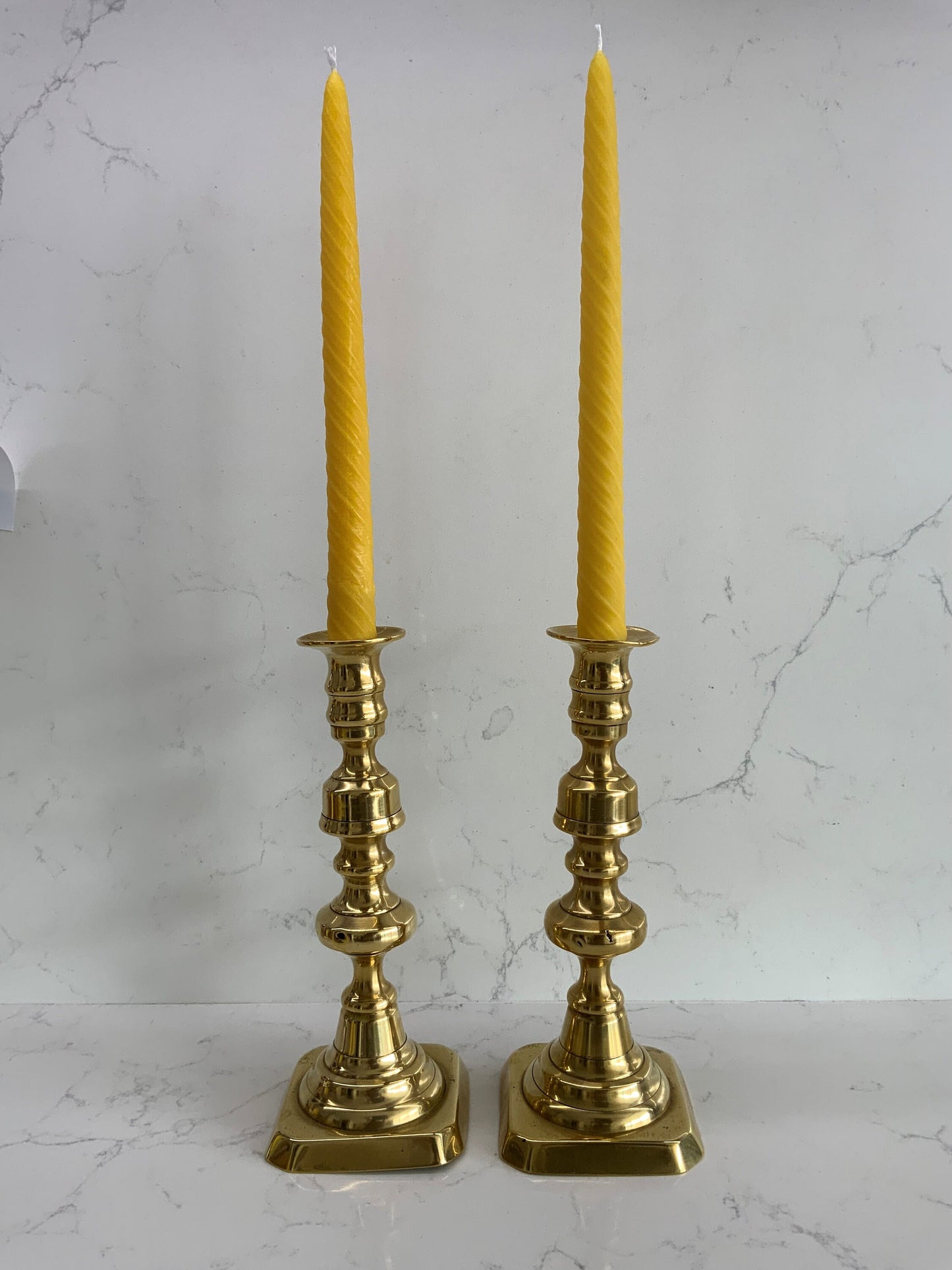 A beautiful pair of large antique Victorian brass candlesticks with 2 matching 100% London Beeswax Candles. Vintage polished brass holders