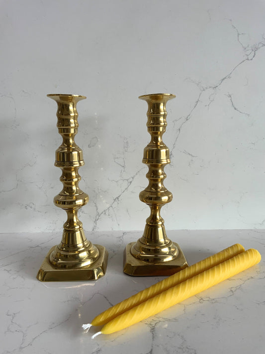 A beautiful pair of large antique Victorian brass candlesticks with 2 matching 100% London Beeswax Candles. Vintage polished brass holders